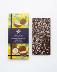 Milene Jardine Toasted Coconut and Lime Leaf bar beside a coconut-flecked dark chocolate bar