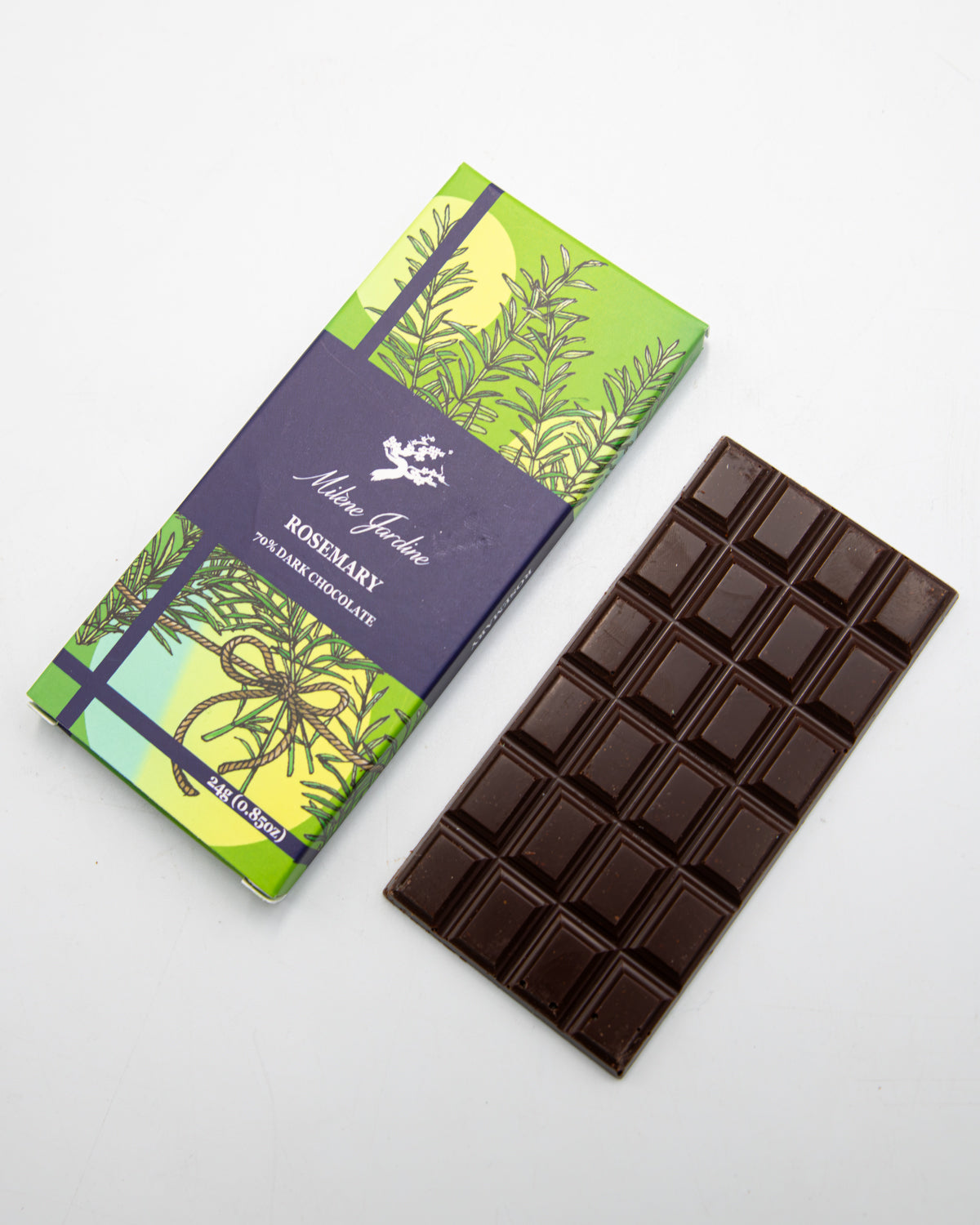 Milene Jardine Rosemary dark chocolate bar in green herb-print wrapping beside the bar