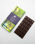 Milene Jardine Rosemary dark chocolate bar in green herb-print wrapping beside the bar
