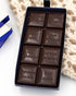 Open Miss Maude's dark chocolate bar with each square stamped with a different flavor