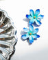 Nach Bijoux Frost Flower earrings in hand-painted blue porcelain beside a silver dish