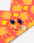 Nach Bijoux asymmetric earrings, a moon and a sun, with blue porcelain flower studs