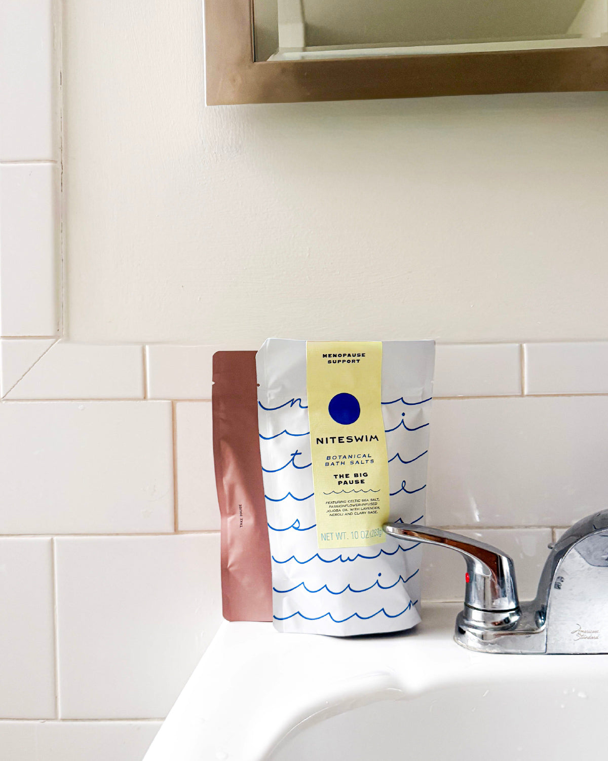Niteswim The Big Pause botanical bath salts pouch on a white bathroom sink
