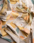 Colorful patterned Turkish towel with a brand logo