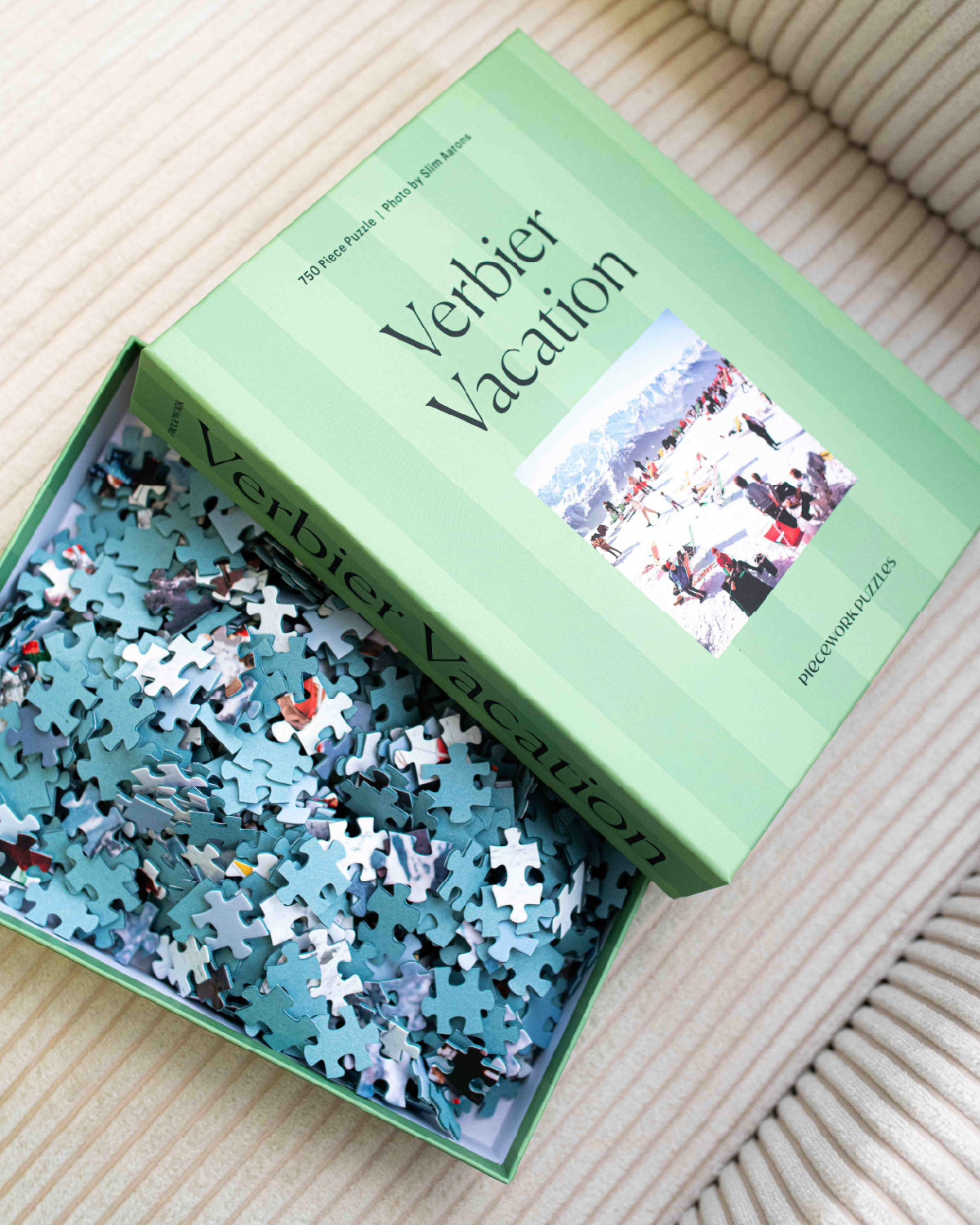 Verbier Vacation 750-piece puzzle open in its mint green box with loose pieces