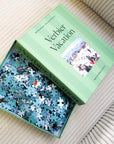Verbier Vacation 750-piece puzzle open in its mint green box with loose pieces