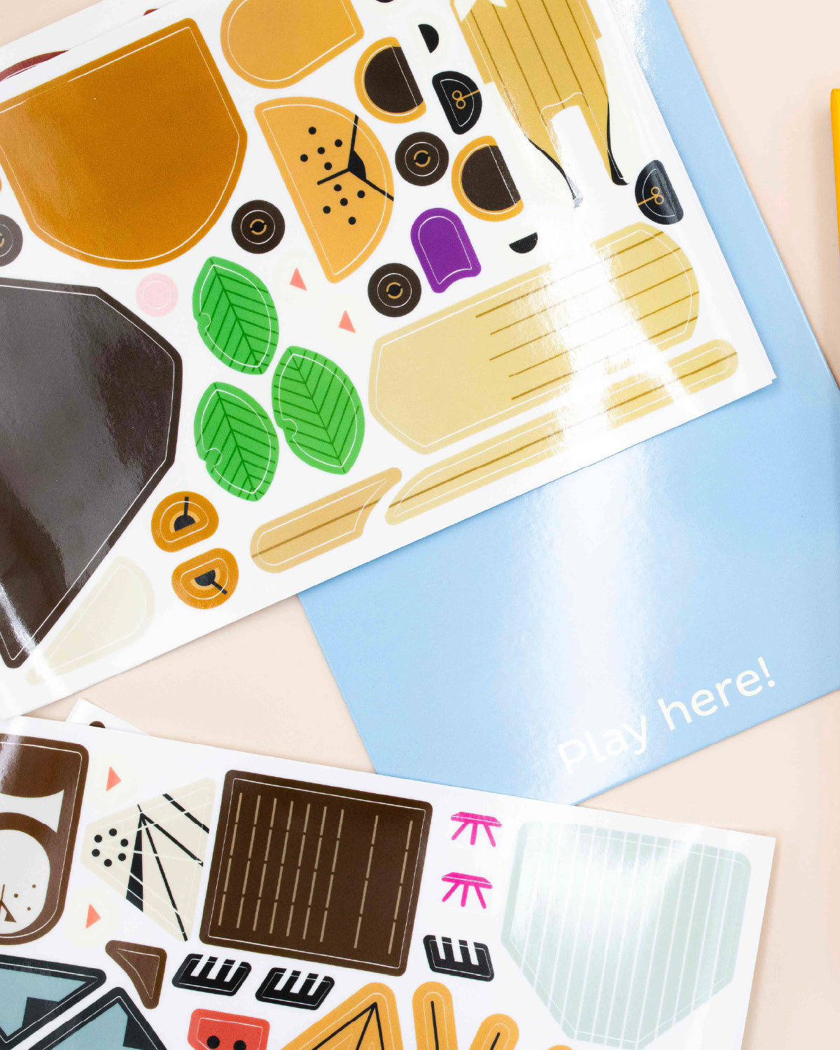 Reusable vinyl sticker sheets of Charley Harper animal shapes on a pale blue playboard