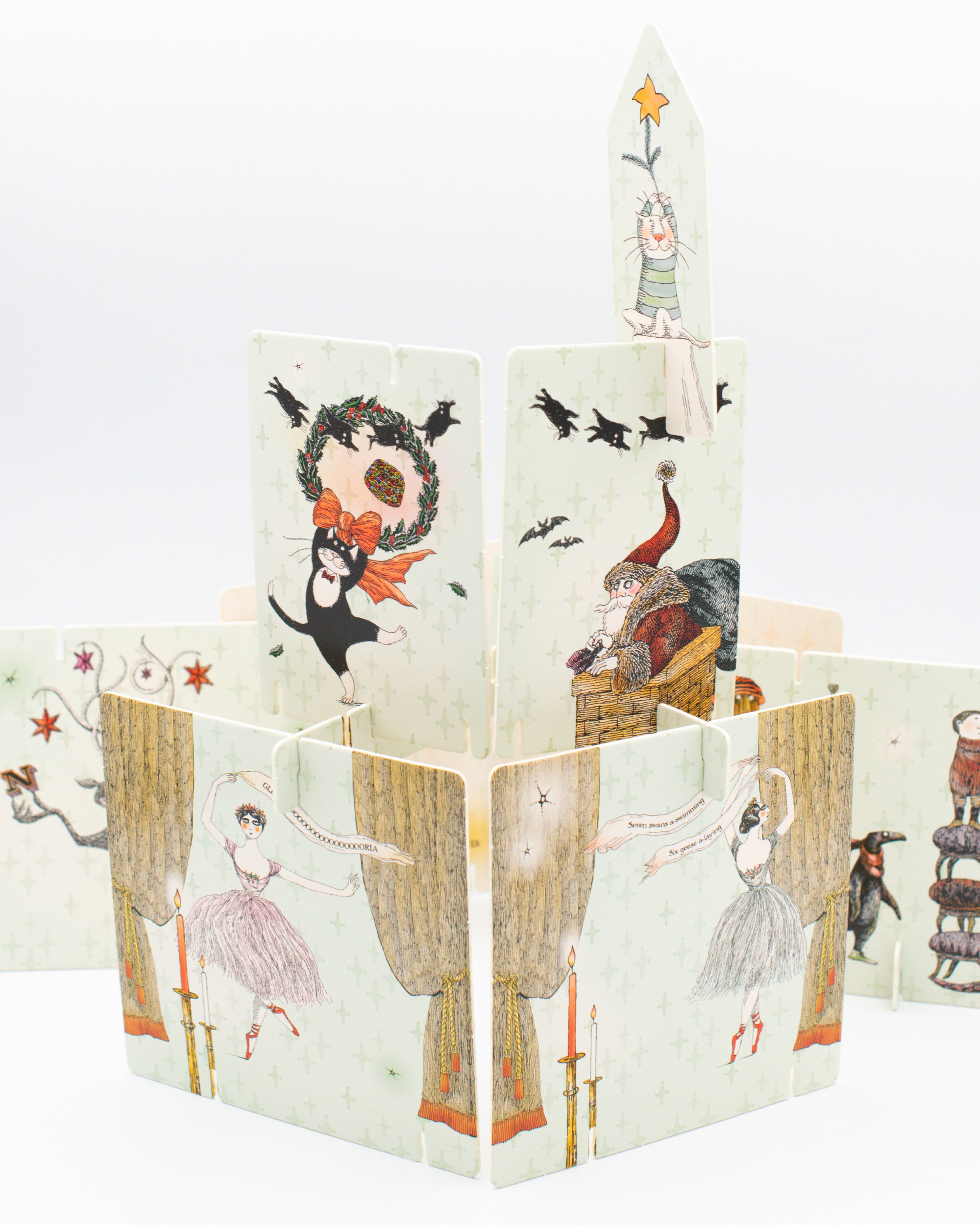 Preview of illustrations on cards from Edward Gorey's Eclectic Decor tabletop craft featuring ballerinas, cats and Santa with holiday decor.