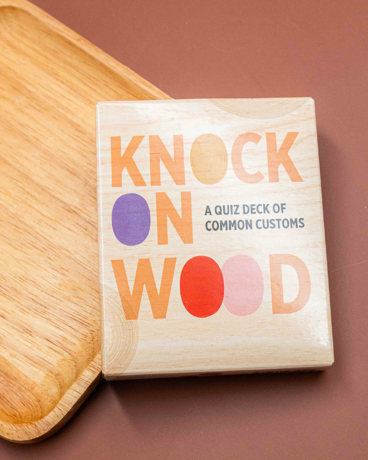 Knock on Wood quiz deck of common customs in a wood-look box on a wooden board