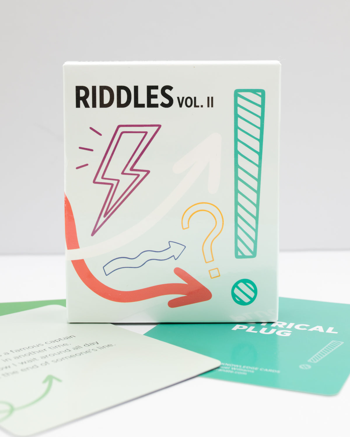 Riddles Vol. 2 card deck from Pomegranate's Card Decks for the Curious, in its box.