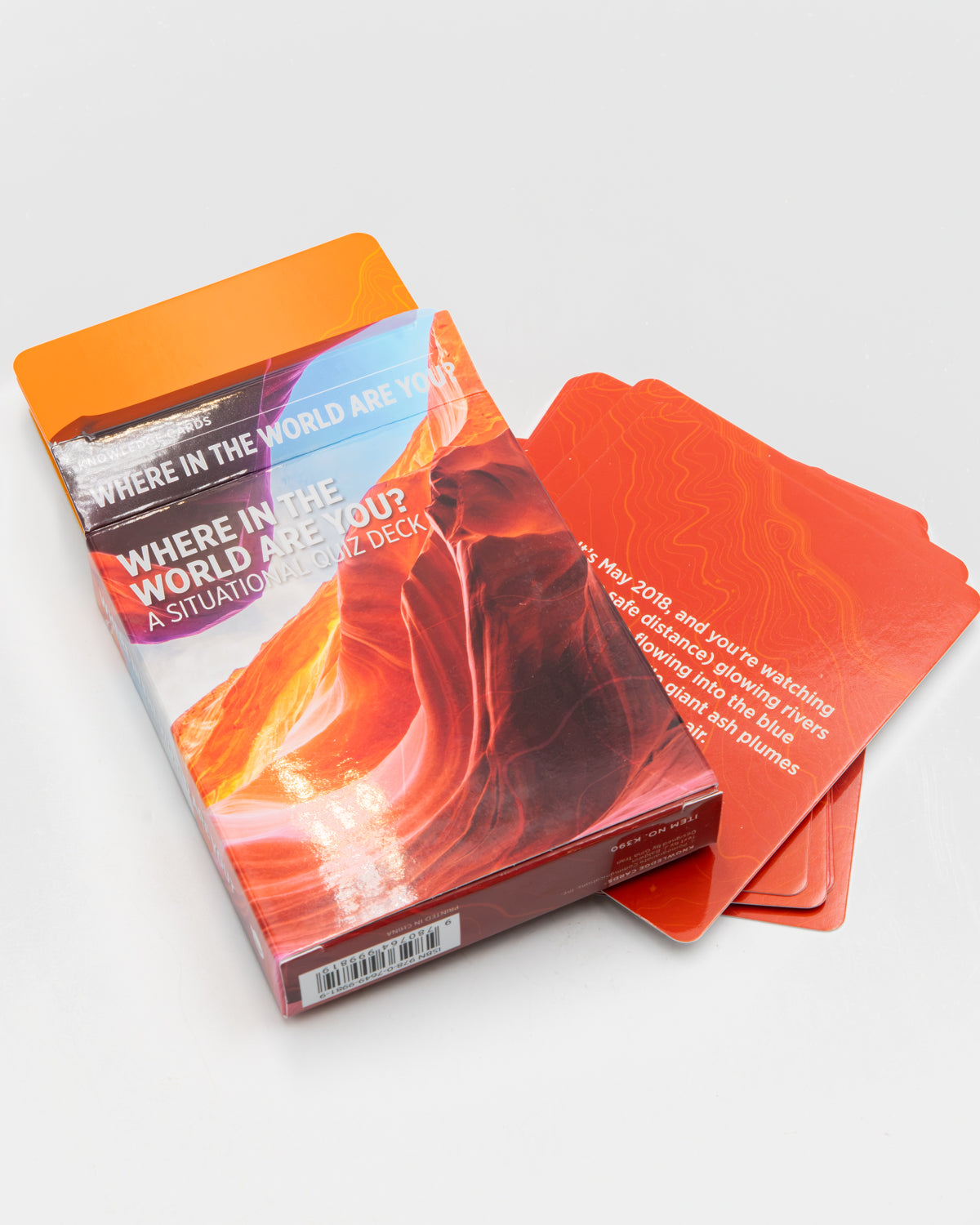 Where in the World Are You? card deck with orange clue cards fanned beside the box