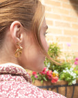 girl wearing chunky gold hoop earrings