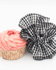 gingham ruffle scrunchie next to a cupcake