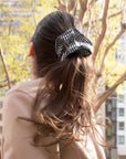 girl wearing a gingham ruffle scrunchie