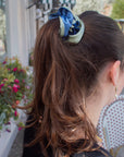 girl wearing reversible ruffle ribbon scrunchie in seafoam green and baby blue