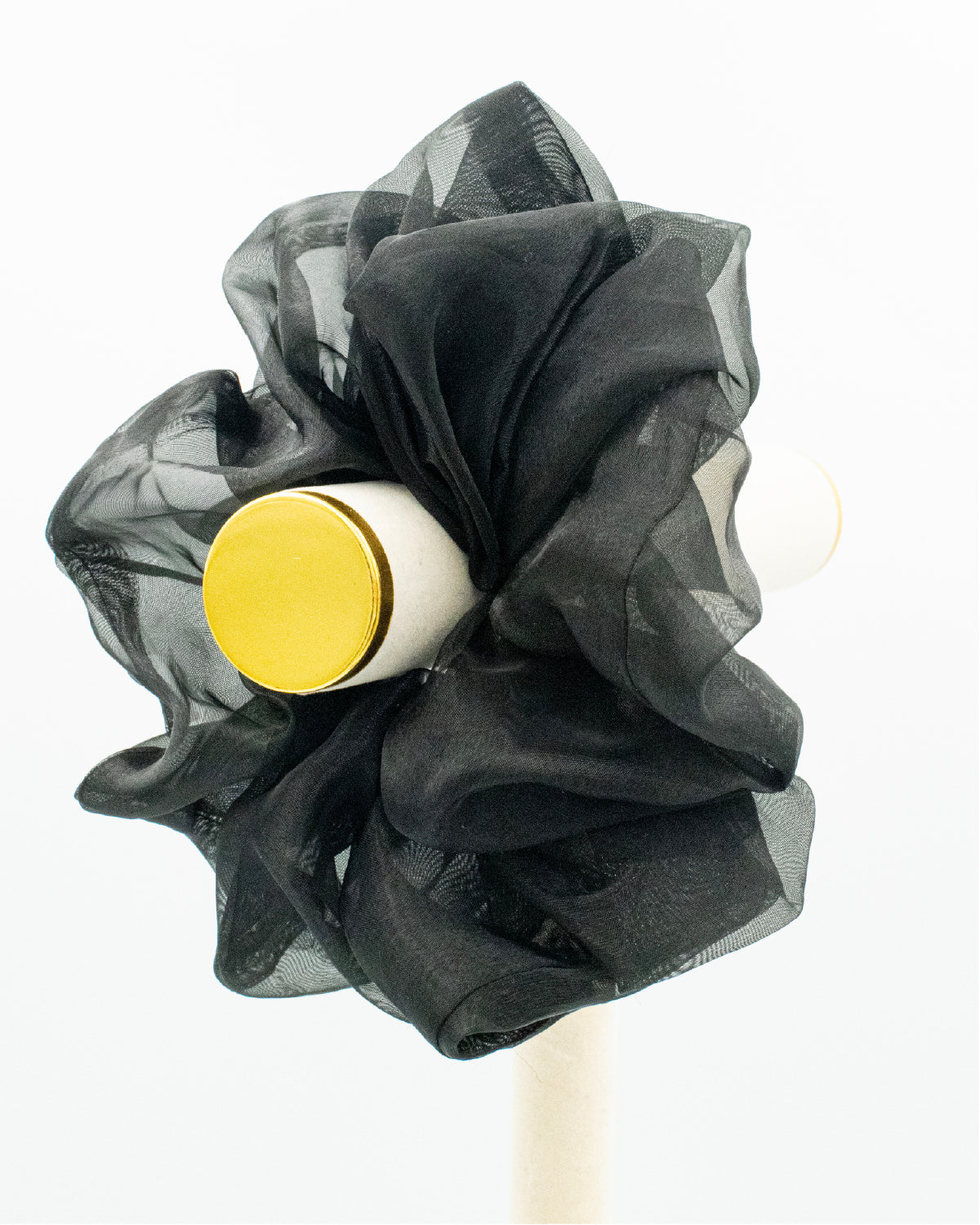 Oversized, black organza scrunchie on a peg.