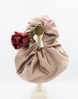 Champagne satin clutch bag with rosette hair ties in garnet red and gold.