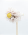 Oversized, cloud colored organza scrunchie on a peg.