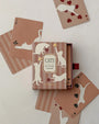 Roomytown Cats playing card deck in a dusty rose box with cards showing cream cat silhouettes