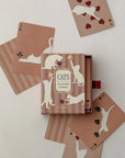 Roomytown Cats playing card deck in a dusty rose box with cards showing cream cat silhouettes