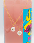 Pearl with set-in peridot or white topaz gemstone on a gold paperclip chain necklace