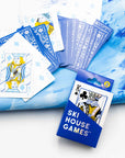 Ski House Games deck fanned out with blue card backs and a skier jack beside the box