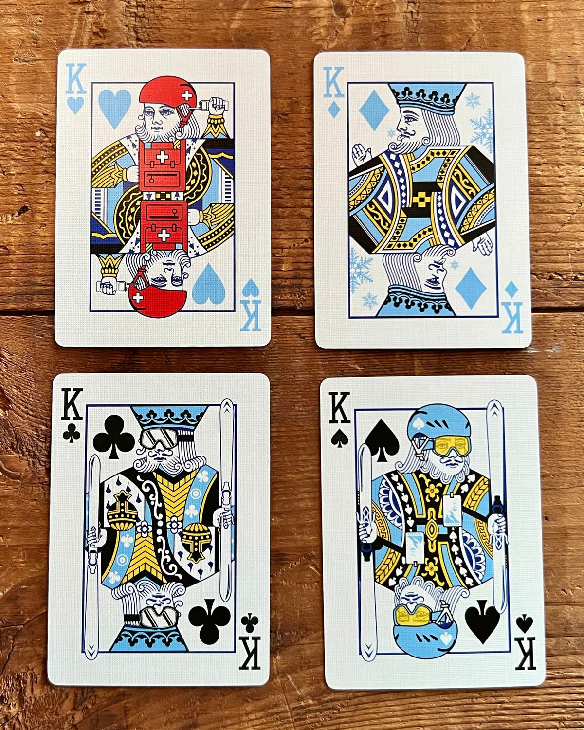 Four Ski House Games kings illustrated as skiers and snowboarders on a wooden table