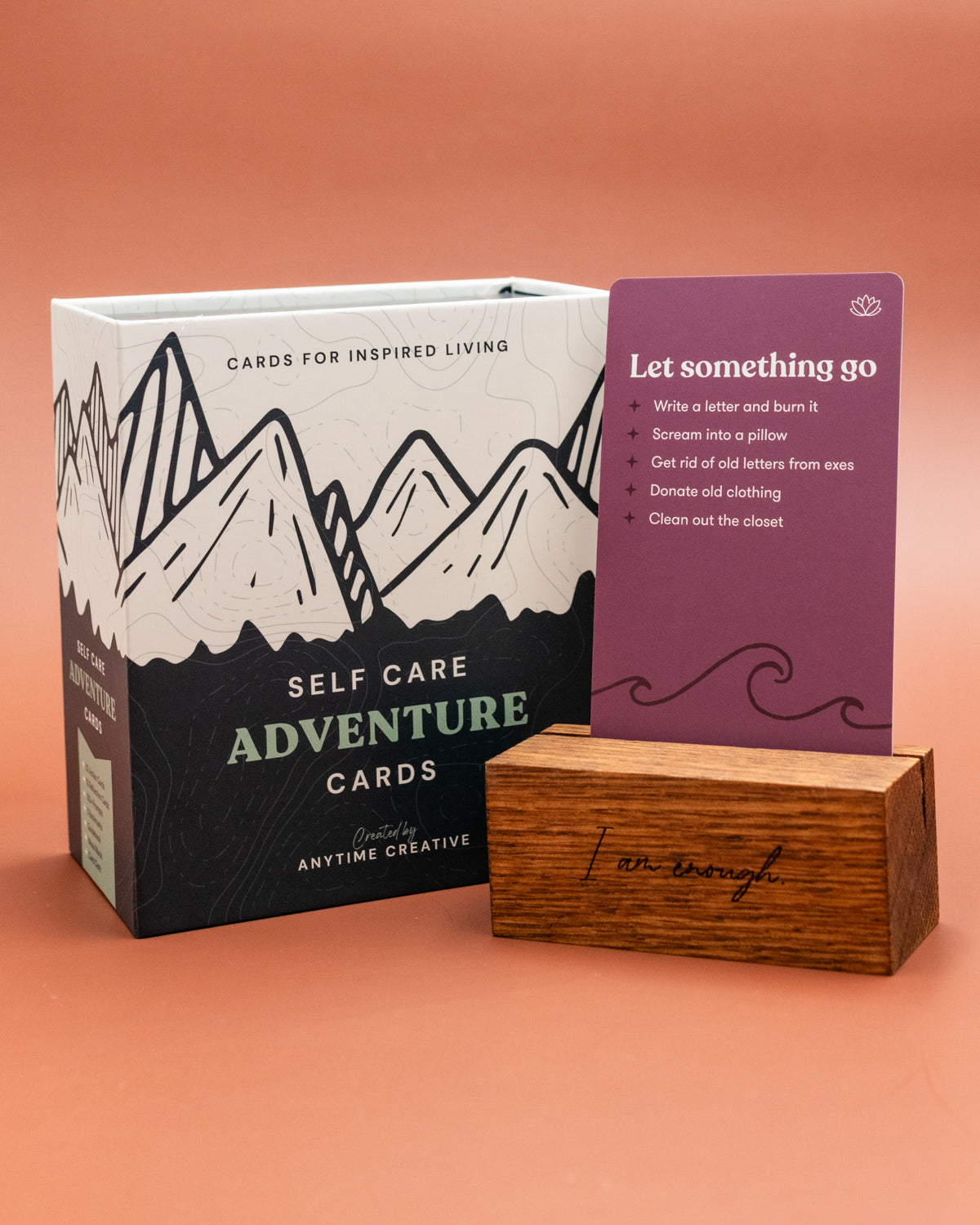 Self Care Adventure Cards box with a Let Something Go card in a wooden stand