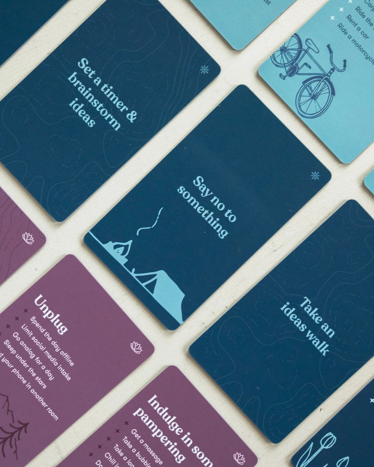 Navy and plum self-care prompt cards like Say no to something and Take an ideas walk