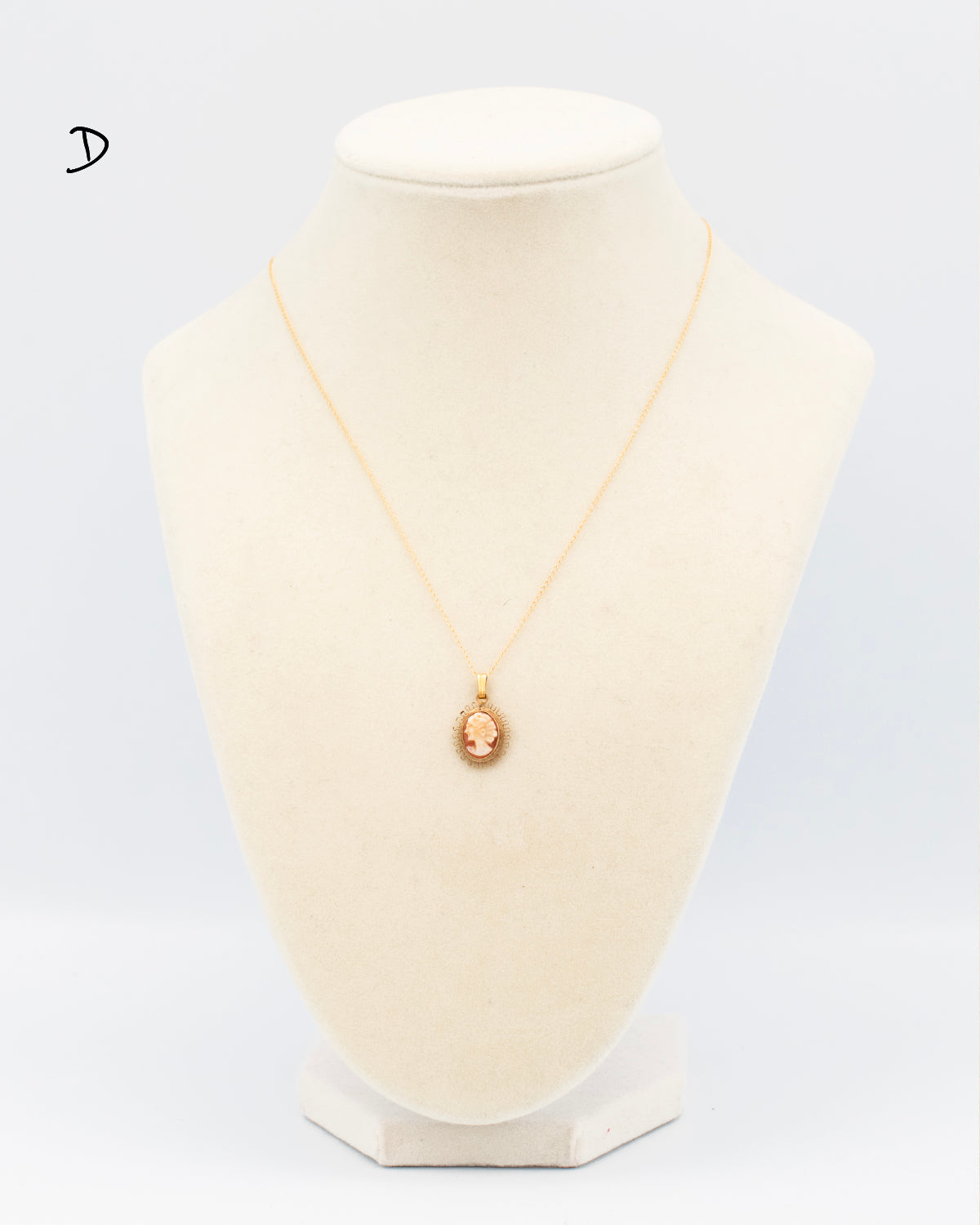 Hand-carved shell cameo in sunburst filigree gold-filled frame on 18&quot; chain, mid-century 1940s-50s displayed on jewelry bust