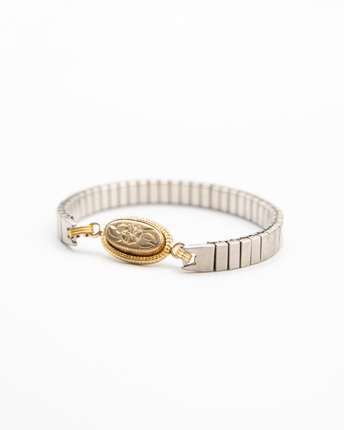 Candlelit Bloom vintage watch band bracelet with a gold oval flower link on white