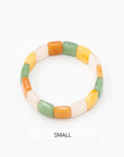 Single chicklet agate stone bracelet featuring rectangular multicolor beads in green, orange, yellow, and cream photographed flat against a white background.