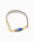 Vintage bracelet with gold clasp and lapis stone on a white background