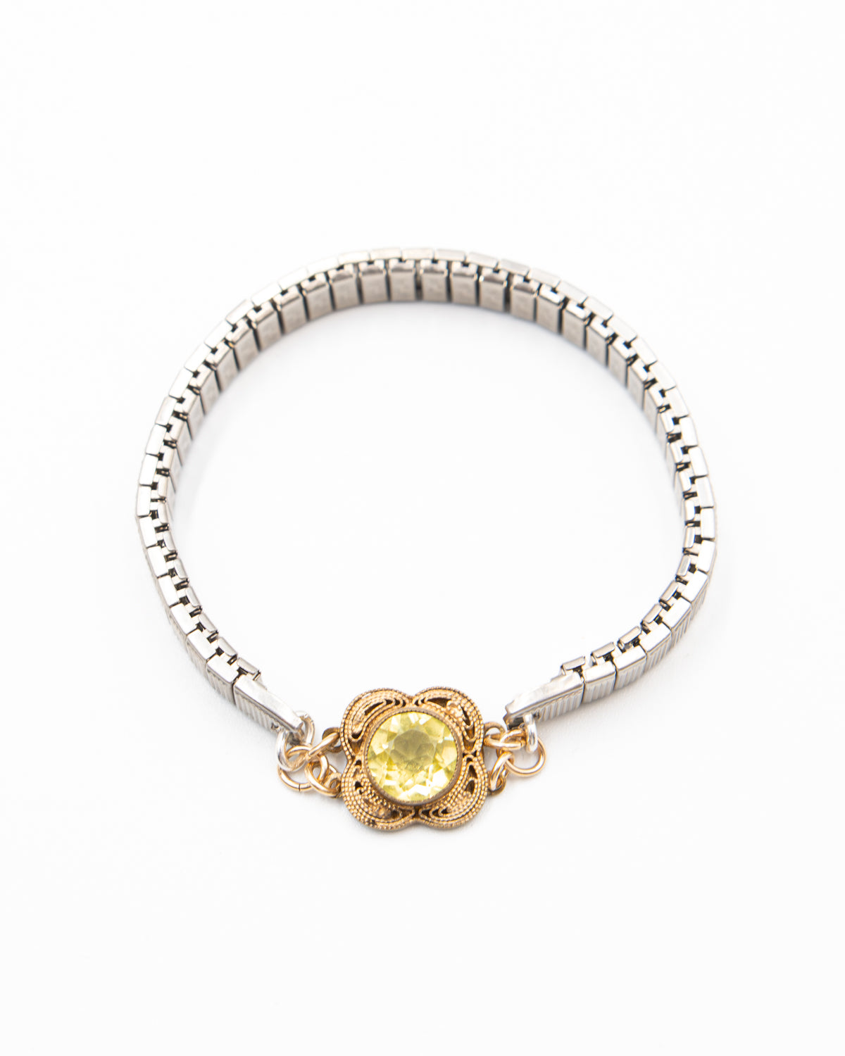 Vintage silver bracelet with a lemon quartz gemstone and gold clasp on a white background