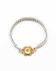 Vintage silver bracelet with a lemon quartz gemstone and gold clasp on a white background