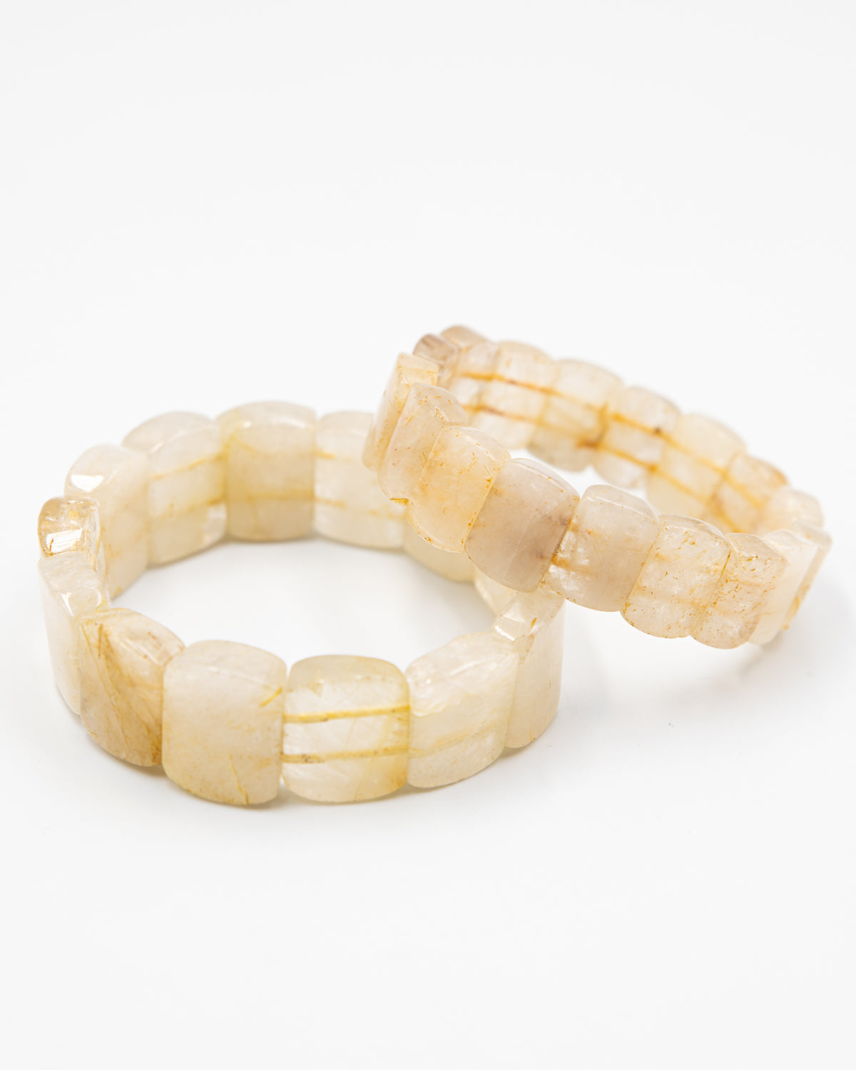 Two rutile quartz beaded stone bracelets arranged together against a white background, showing their translucent, golden-flecked beads.