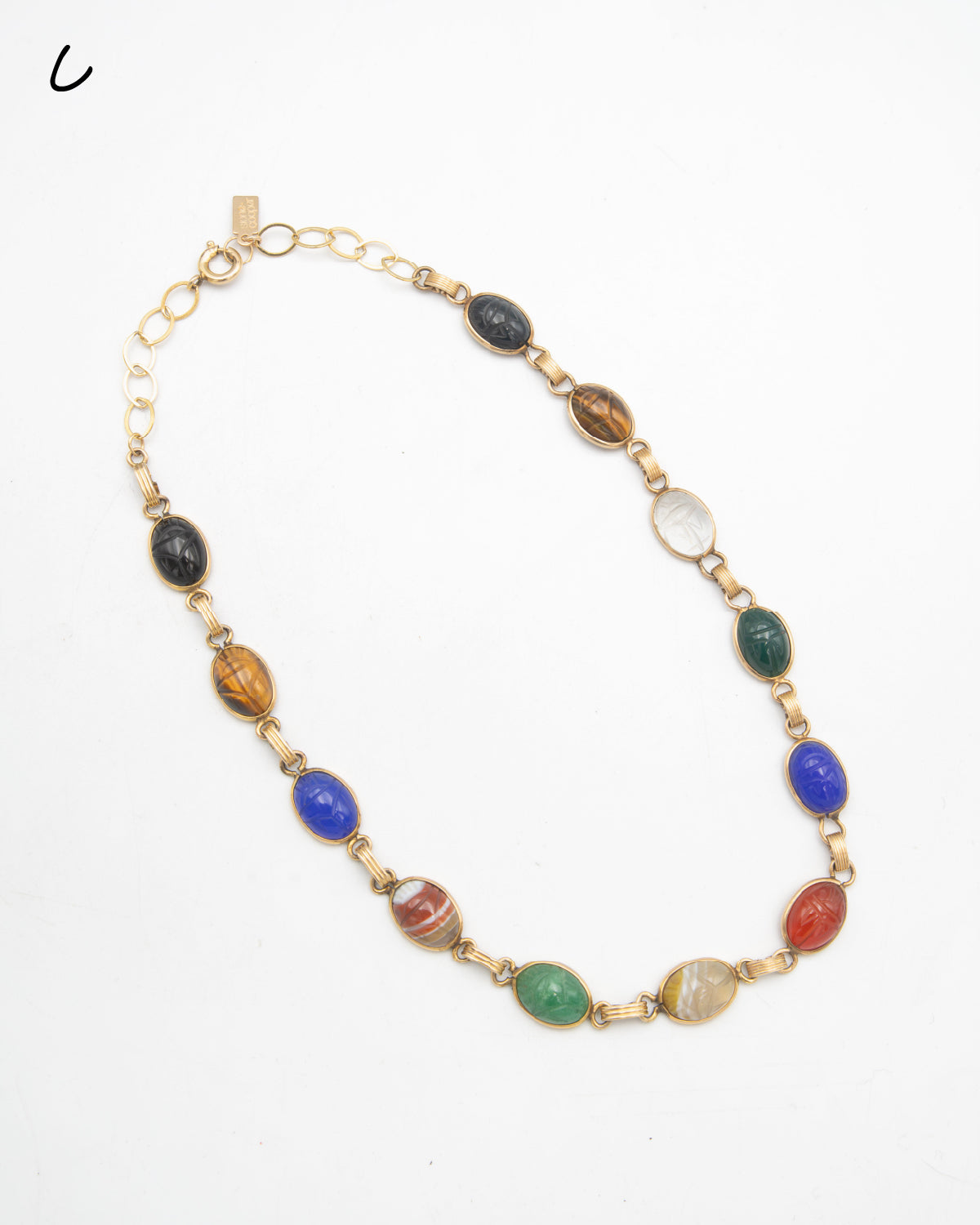 A vintage gold-filled chain necklace featuring a series of oval, multi-colored scarab stone beads in various patterns and hues, displayed on a clean white background.