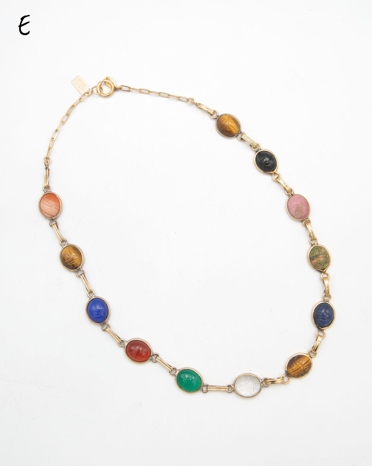 A gold-filled necklace featuring multiple oval scarab gemstone beads in various colors including brown, pink, blue, red, green, and clear, displayed on a white background.