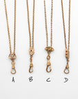 Four gold-filled Victorian-era chatelaine chain necklaces with small decorative pendants labeled A, B, C, and D on a plain white background.