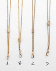Four gold-toned chain slider necklace options labeled A, B, C, and D, shown flat against a white background with handwritten labels below each necklace.