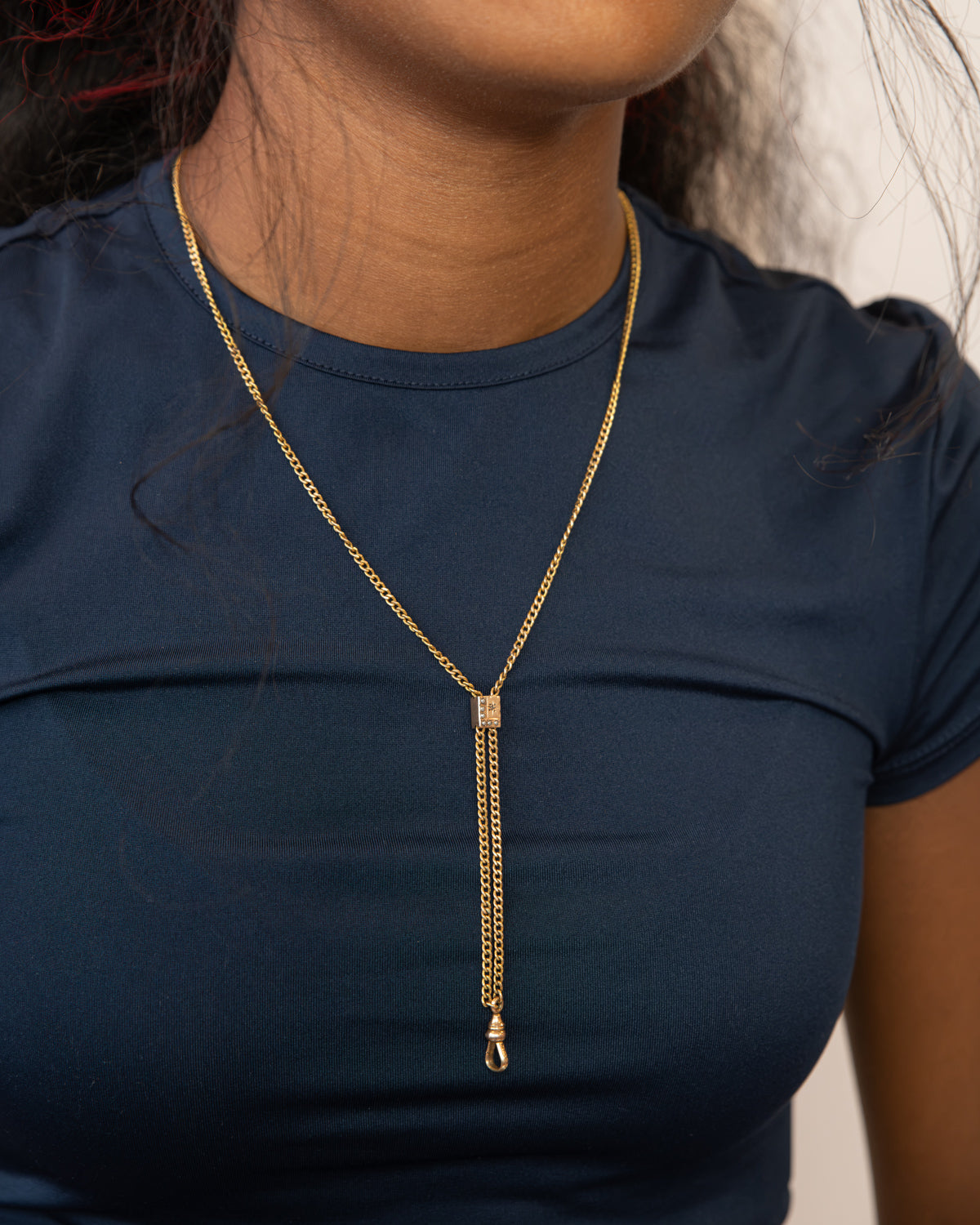Woman wearing a 19th century Victorian chatelaine slider necklace with encrusted seed pearl stones. 