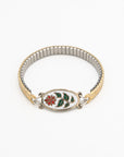 Winter Bloom bracelet with an enameled red and green flower link on a gold-fill watch band