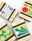 Four Studio Wald wooden flower presses in cornflower, poppy, dandelion and forget-me-not prints
