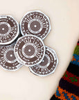 Taza Cacao Puro 70% dark chocolate discs in brown and white wrappers, stacked loosely