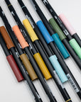 Twelve Tombow ABT dual brush pens laid out in rust, ochre, sage, sky blue and pale pink.