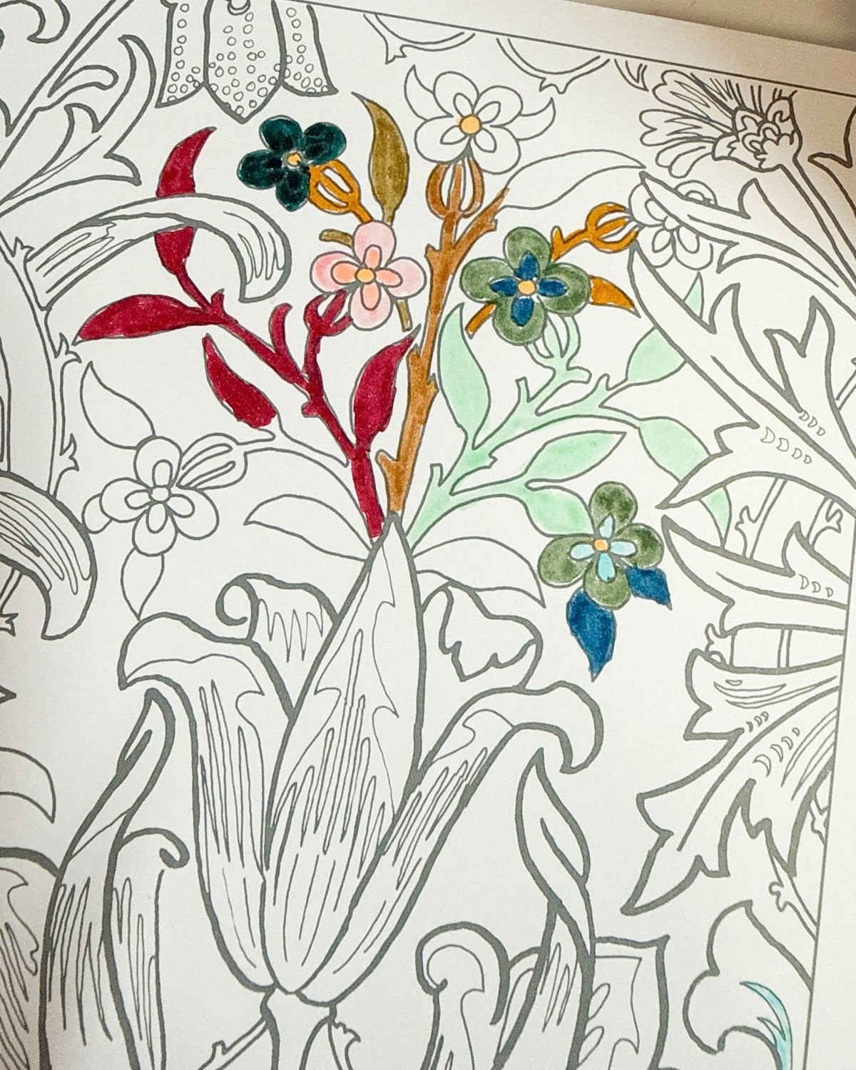 Floral coloring page partly filled in with red, green and blue Tombow brush pen ink.