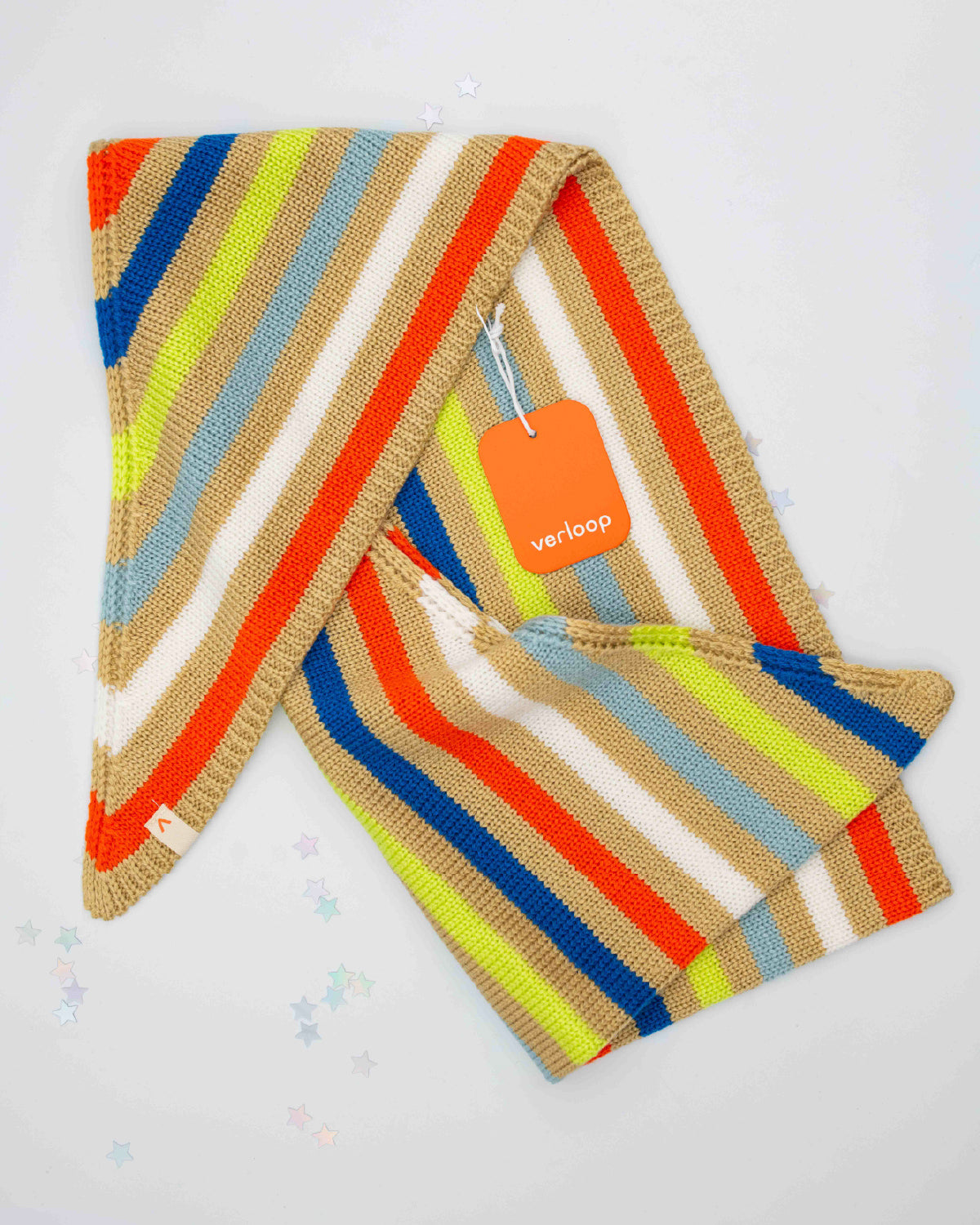 Folded Verloop triangle scarf in bright stripes with its orange hang tag