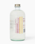 Back of the Glitter Simple Syrup bottle with its label and shimmering syrup inside