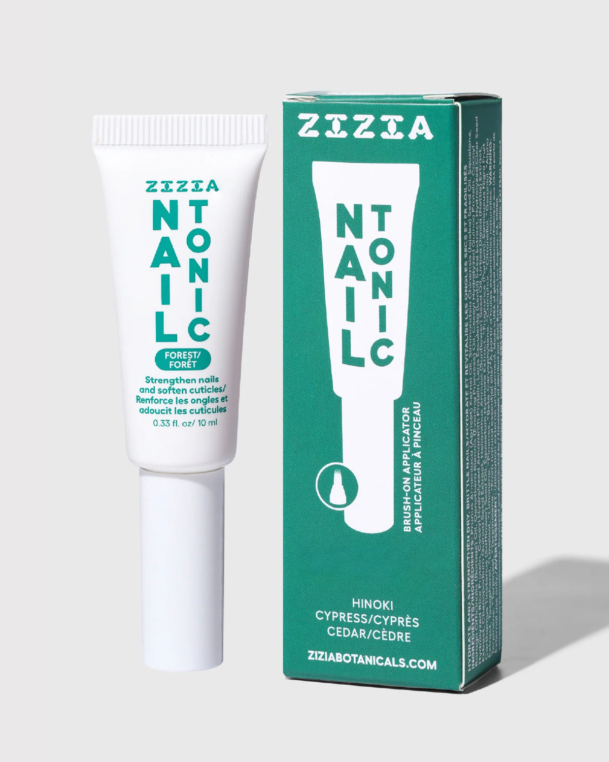 Zizia Nail Tonic cuticle oil tube next to its green box, in a hinoki, cypress and cedar scent