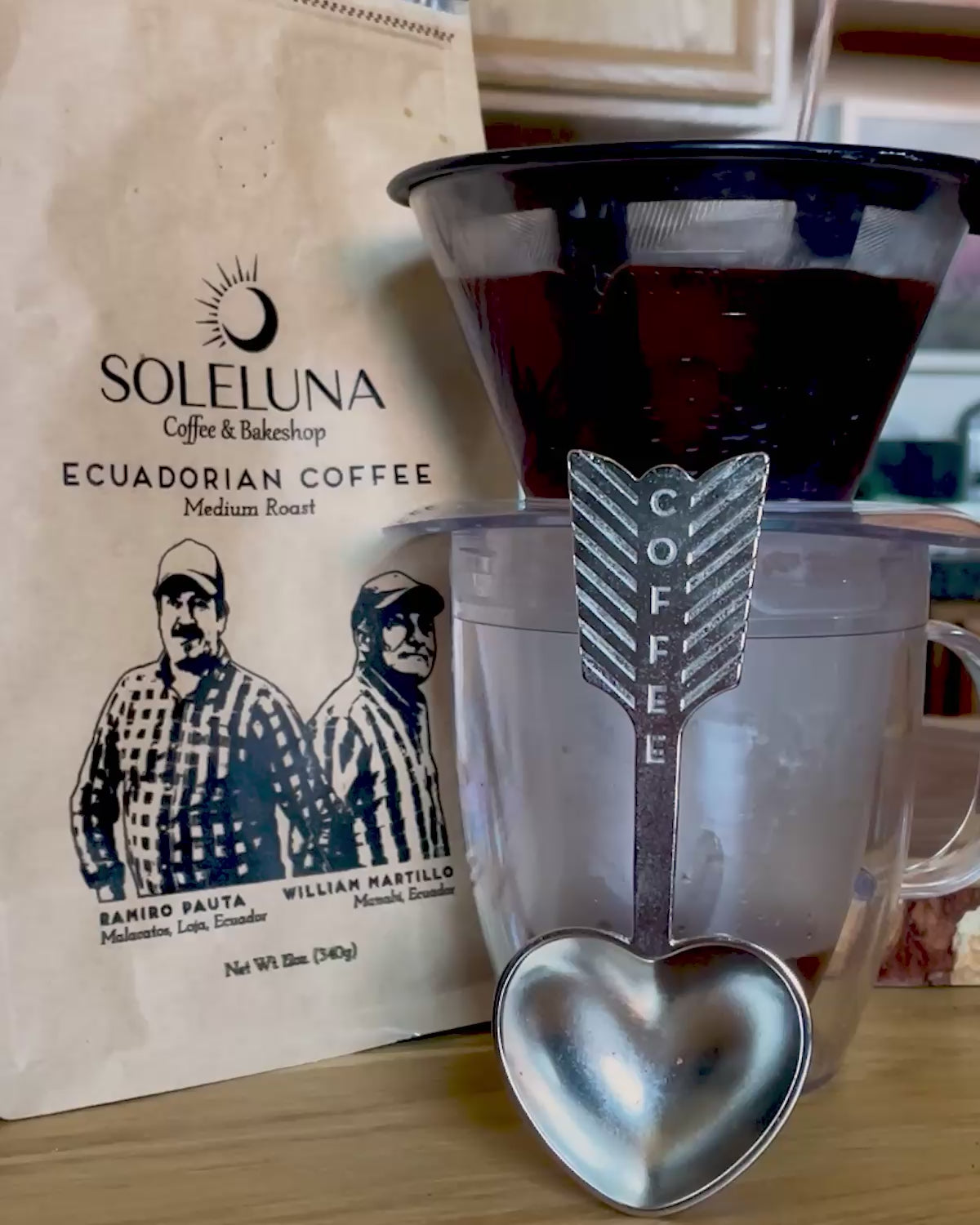 Video showing a handmade heart-shaped coffee scoop and Ecuadorian coffee being made in a pour-over cup system.